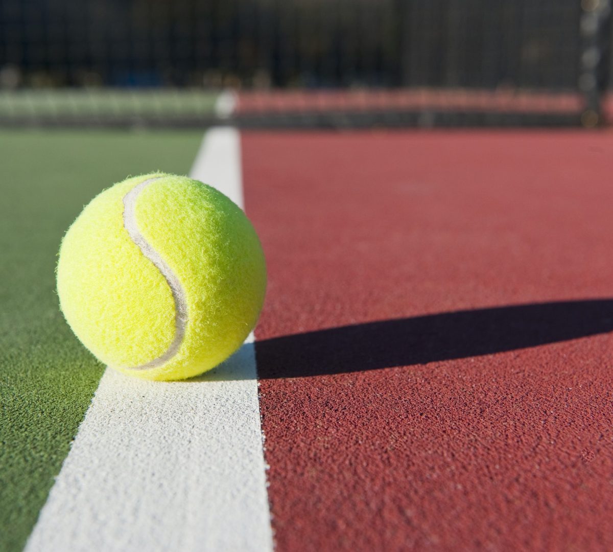 Tennis Ball Sitting on Court